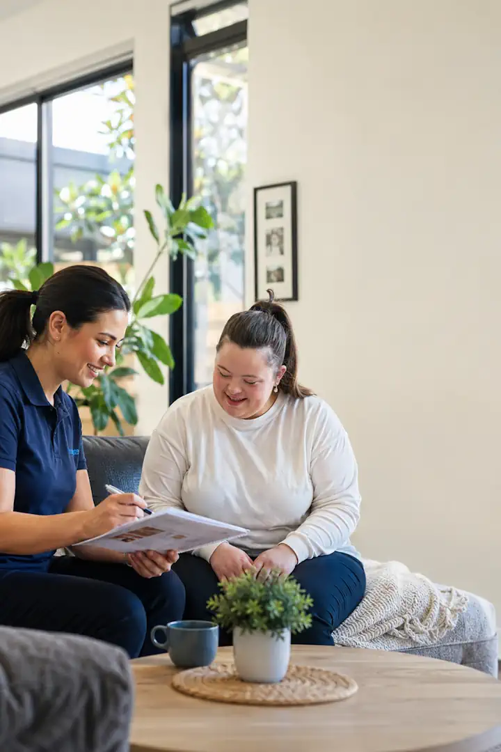 NDIS support worker reviewing a personalised support plan with a participant in a Melbourne home